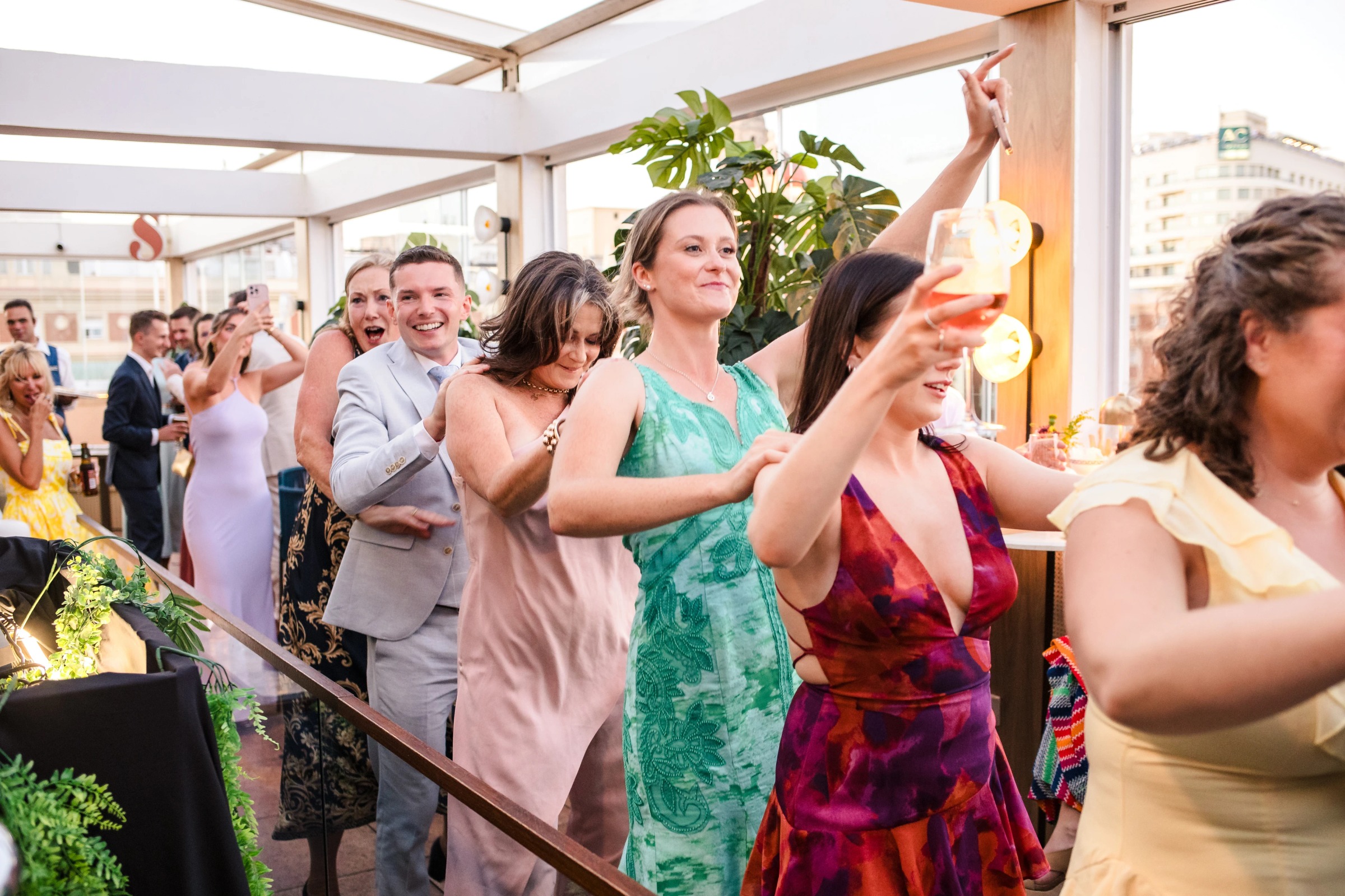 Guests dancing and celebrating at a rooftop reception, raising their arms in joy. — Wedding at Hotel Only You, Malaga, spain