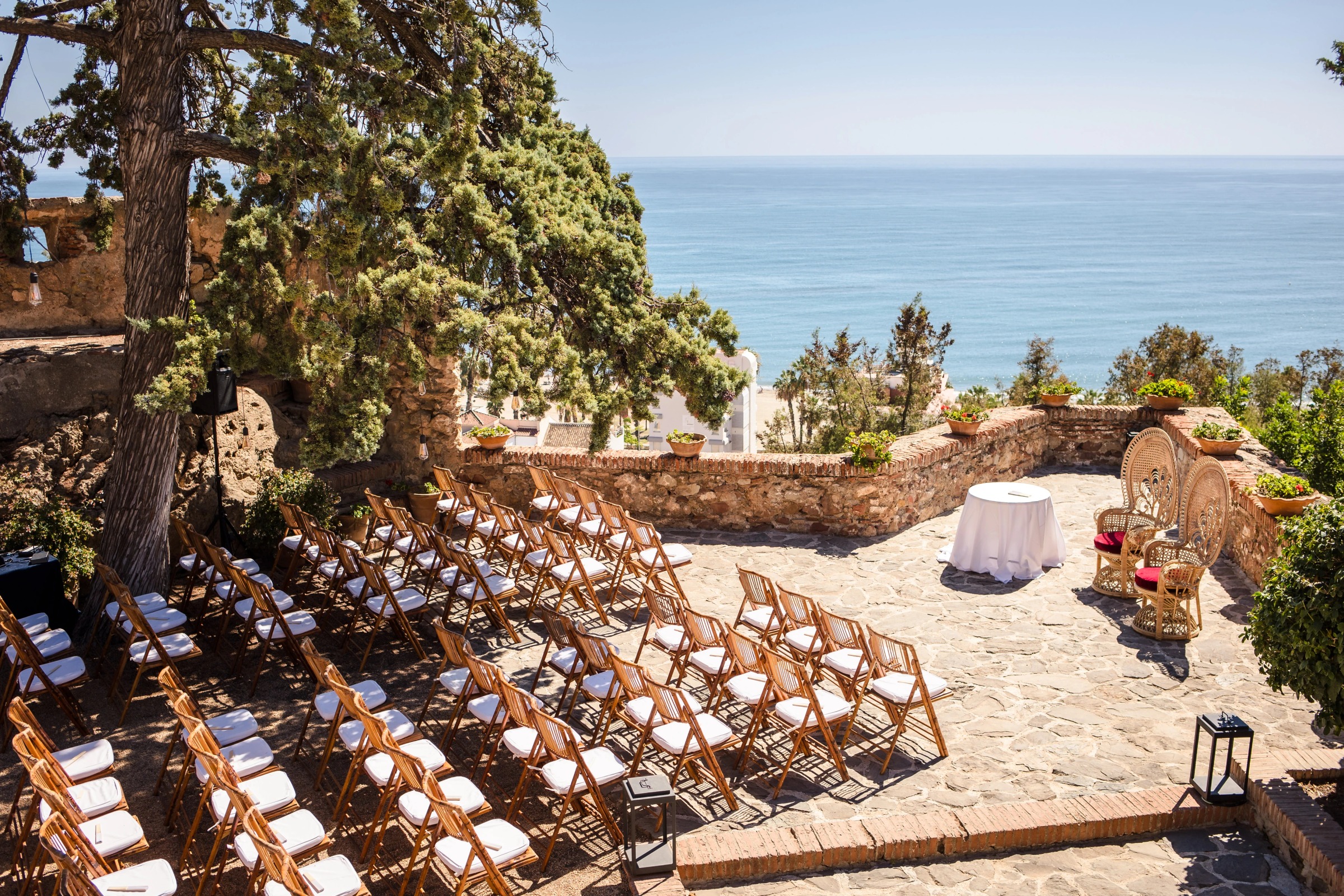 Guests seated in rows awaiting an outdoor ceremony on a clifftop overlooking the ocean. — Wedding at Hotel Only You, Malaga, spain