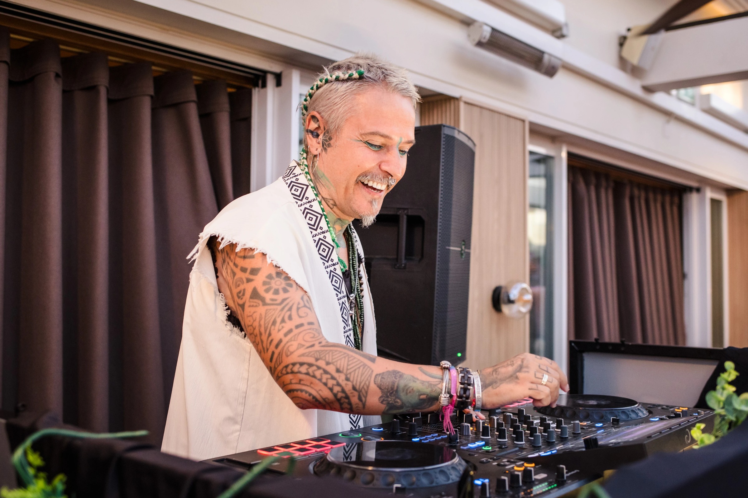 Man DJing at a wedding reception, smiling while operating turntables. — Wedding at Hotel Only You, Malaga, spain