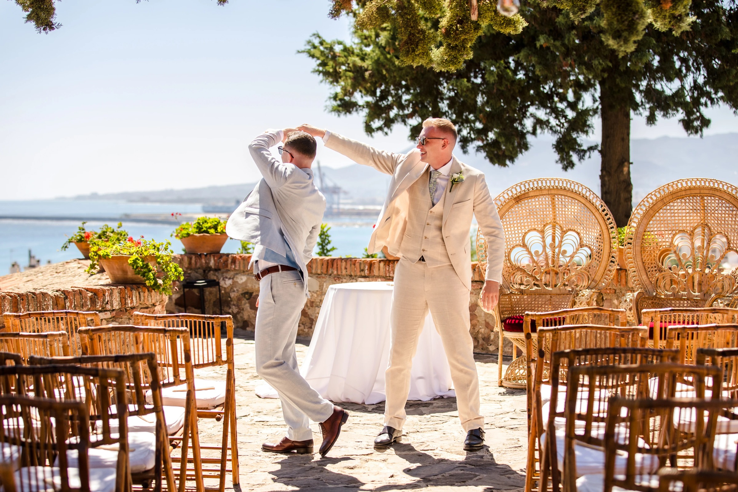 Two men dancing together at an outdoor wedding reception by the water. — Wedding at Hotel Only You, Malaga, spain
