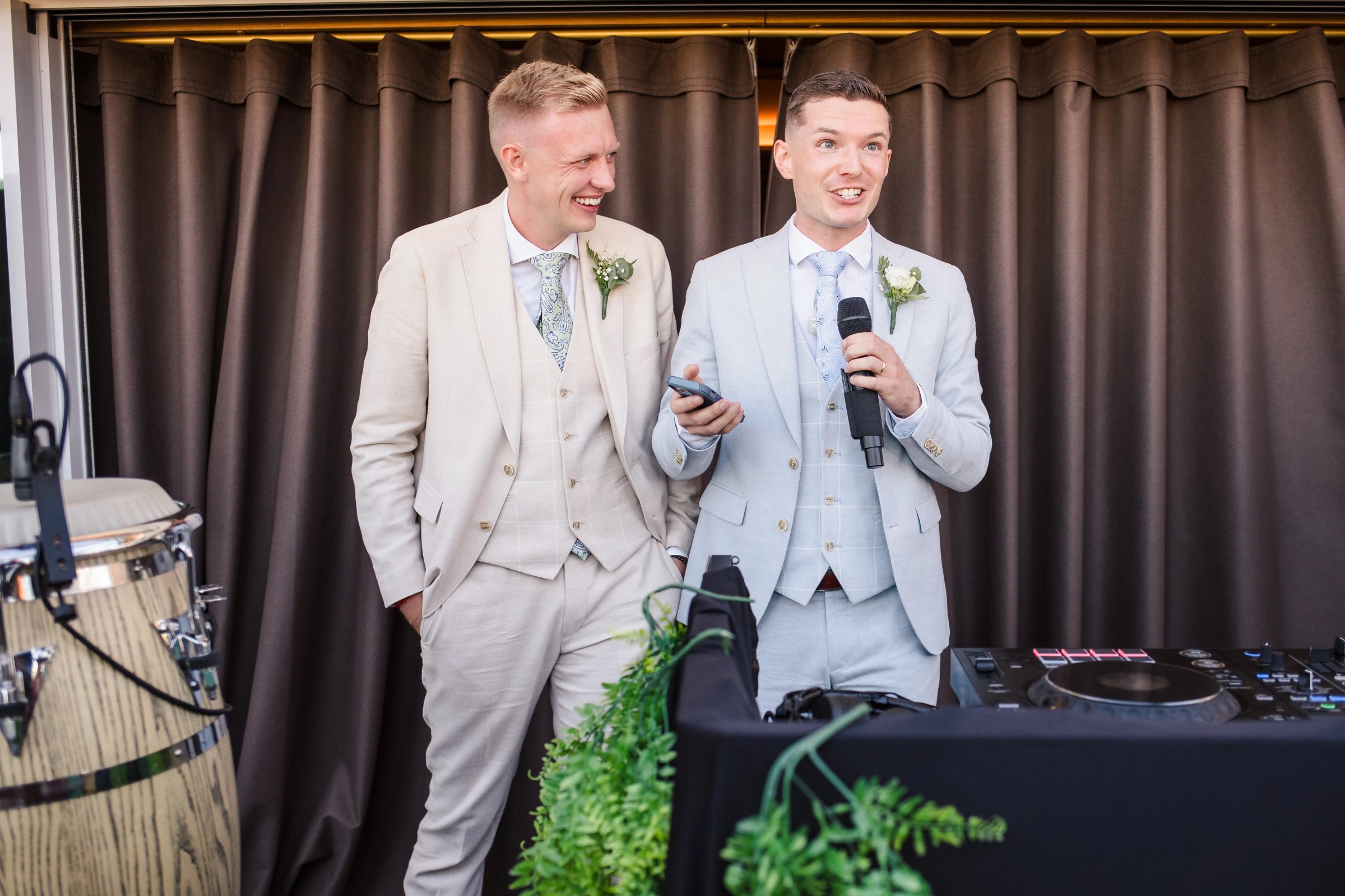 Two men in suits speak at a microphone during a wedding reception toast. — Wedding at Hotel Only You, Malaga, spain